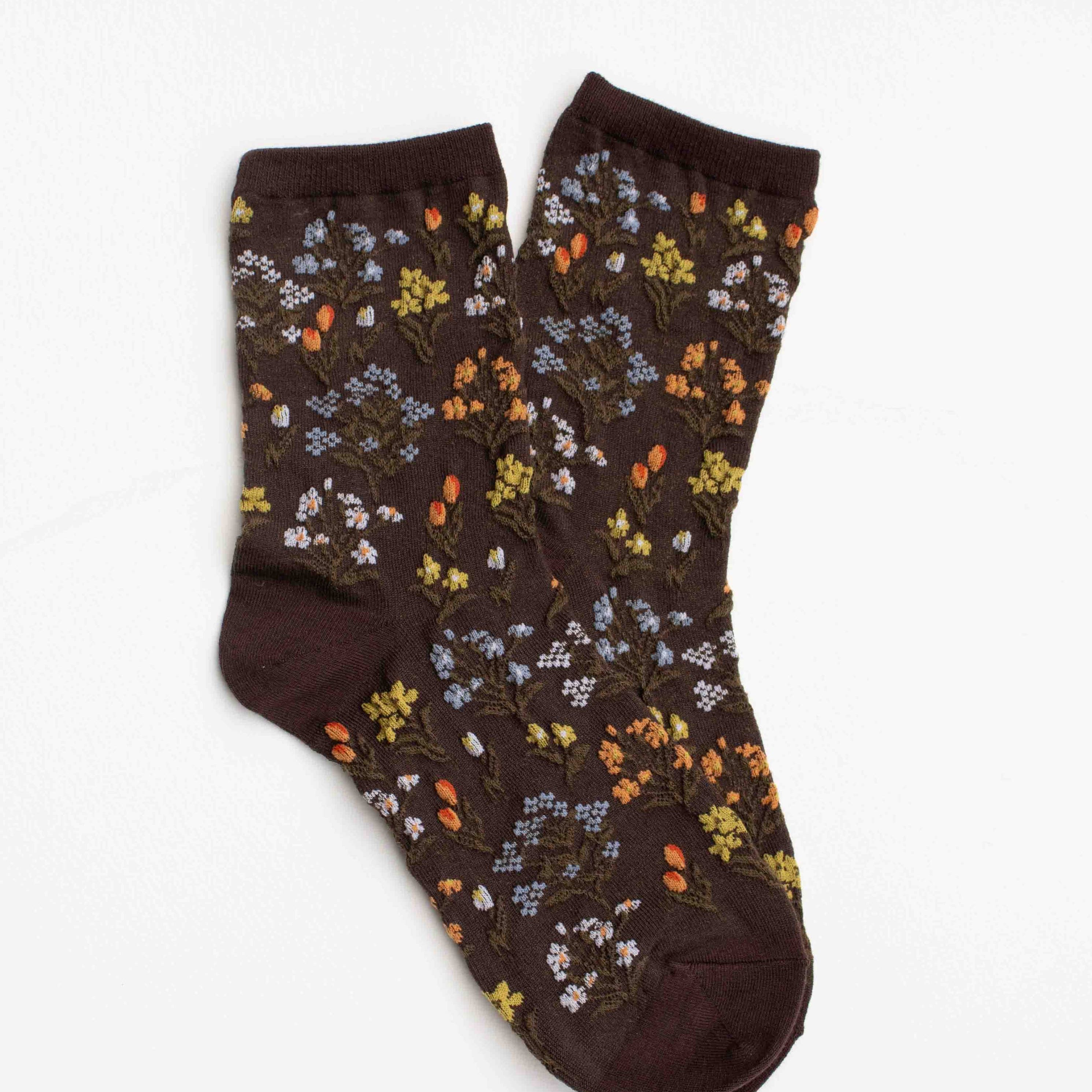 Pair of brown socks with floral pattern on a white background