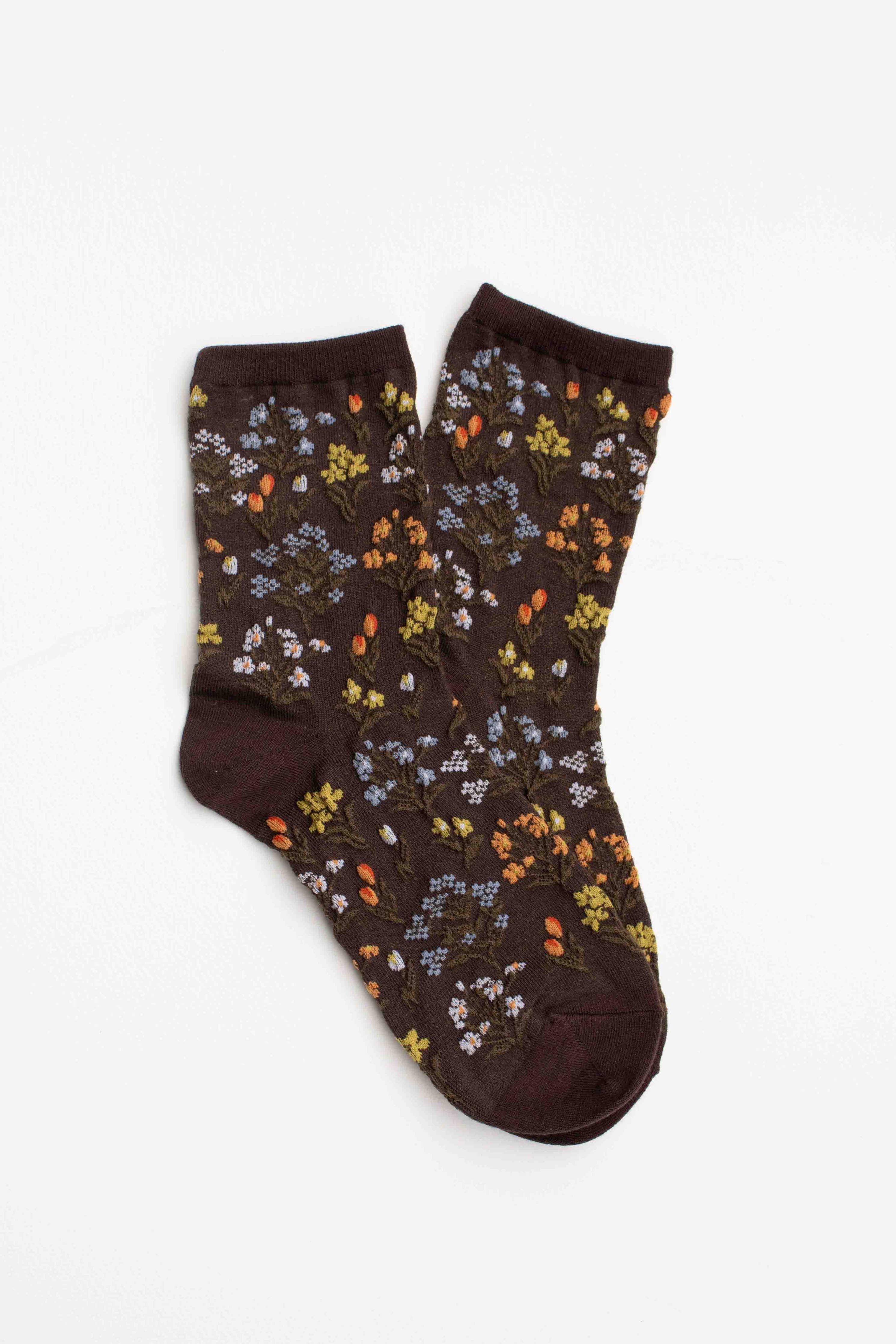 Pair of brown socks with floral pattern on a white background