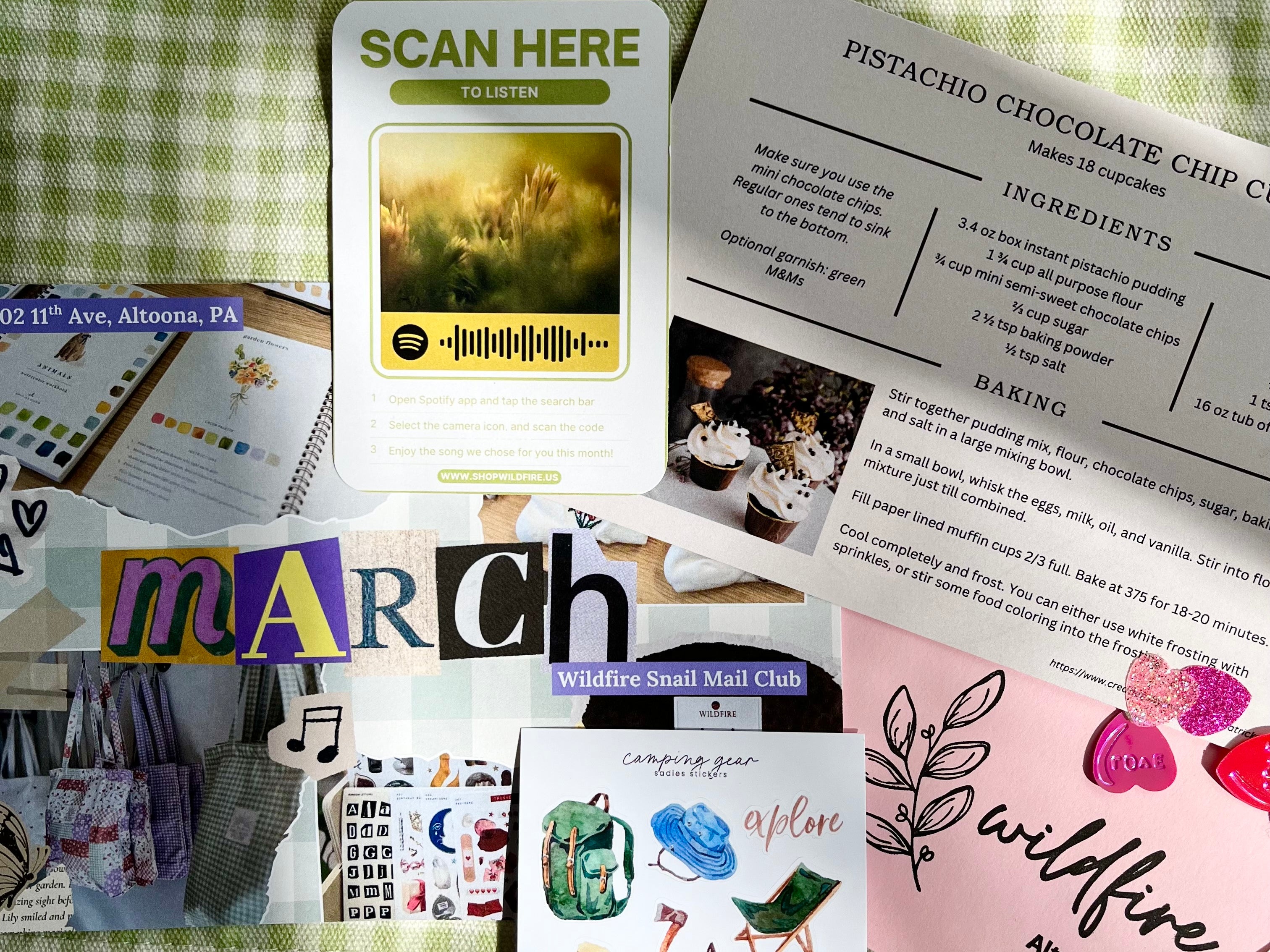 Collection of cards and stationery items on a green checkered fabric background