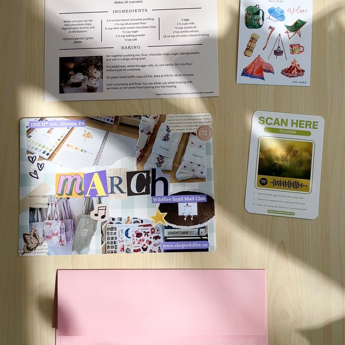 Collection of printed materials on a wooden surface with 'wildfire' branding.