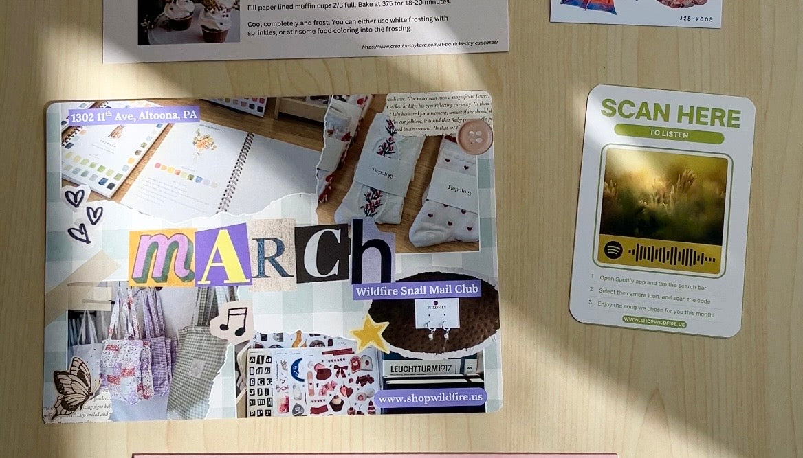 Collection of printed materials on a wooden surface with 'wildfire' branding.