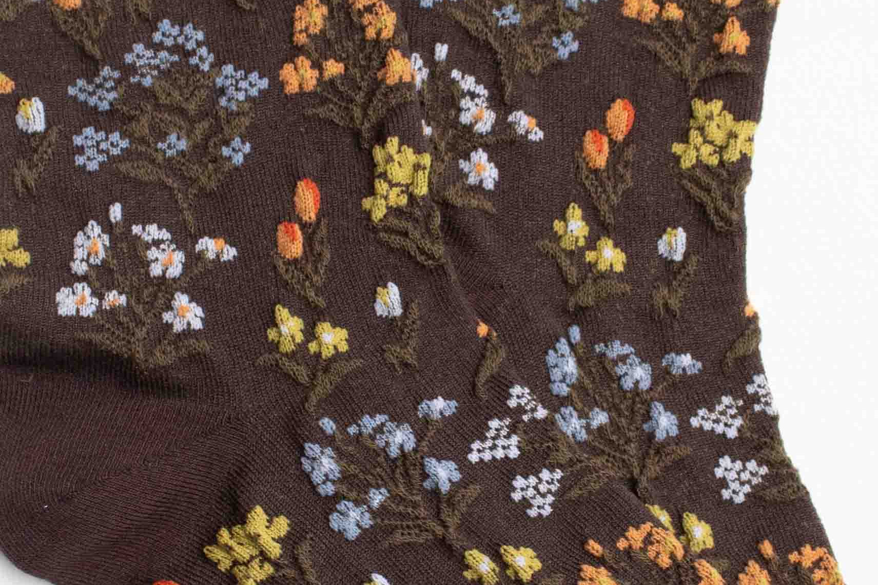 Brown socks with floral pattern on a white background