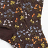 Brown socks with floral pattern on a white background