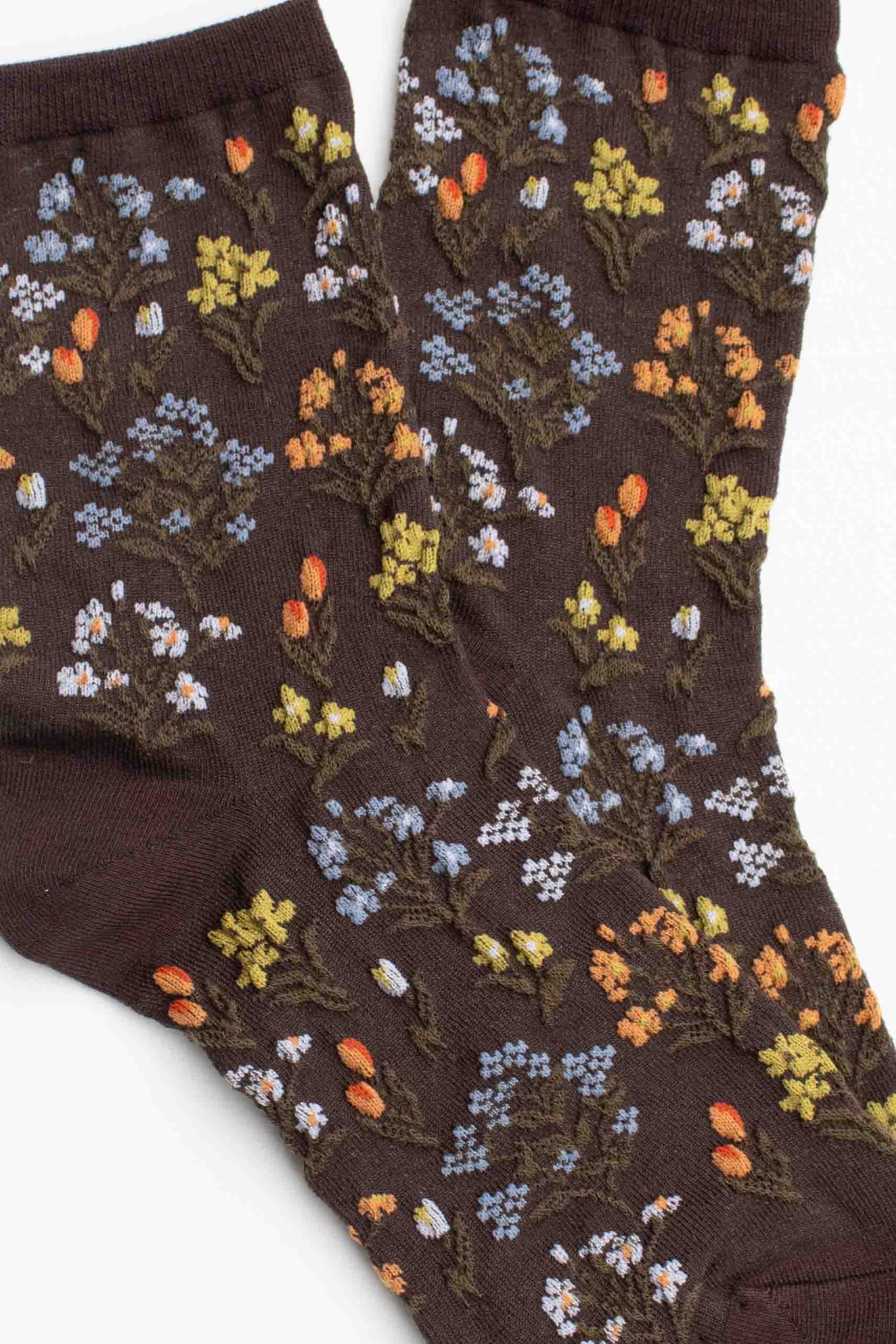 Brown socks with floral pattern on a white background