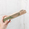 This bamboo toothbrush comes in eco-friendly packaging. Because it is made of paper, it can be composted after opened. The toothbrush itself is made of bamboo and has soft, white bristles.